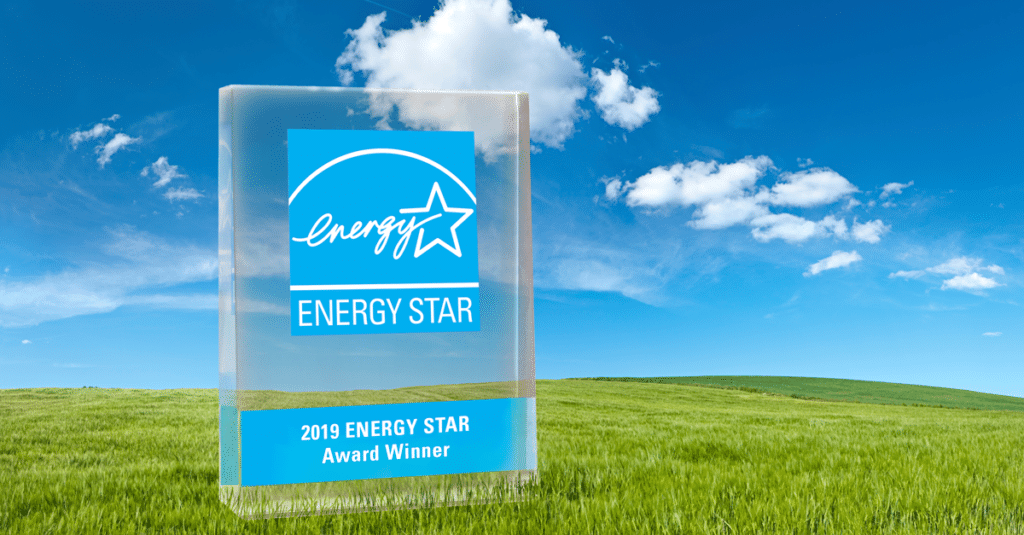 Energy Star award on green grass with bright clouds