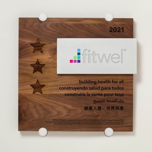 Wood building plaque with silver standoff brackets for Fitwel certification