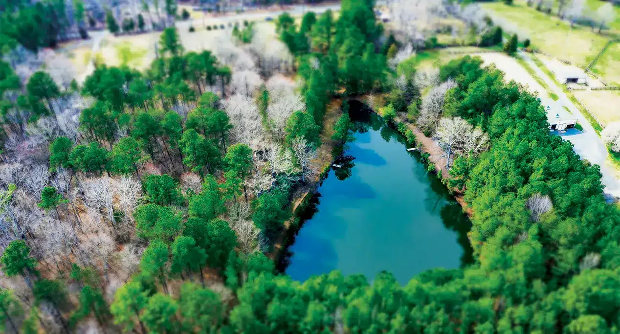 Aerial view of the blue water pond during the summer at Array, North Carolina's first net-zero community