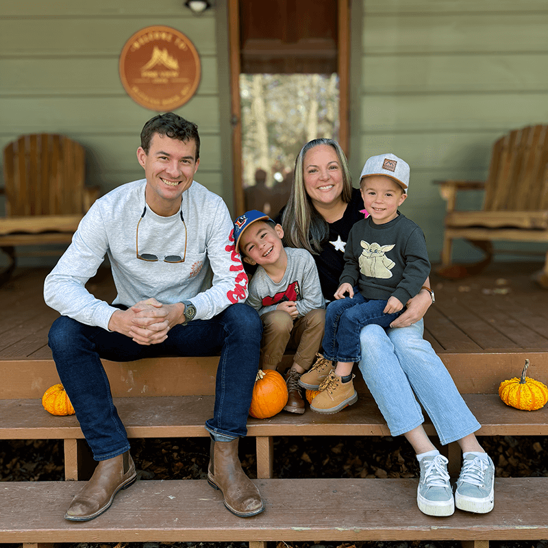 Will Etheridge and his family outside a mountain cabin