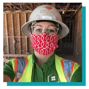 Rachel, Project Manager at Southern Energy Management, at construction site wearing ppe and mask