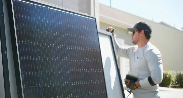 Solar Installer Inspecting Panels