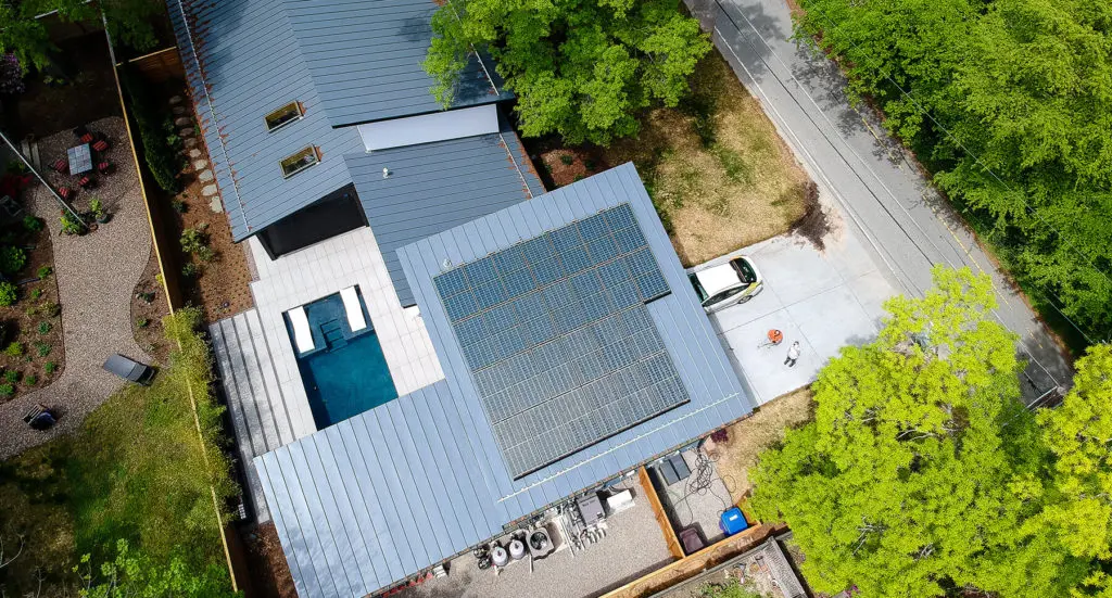 Aerial view of a blue metal roof with poly solar system installed