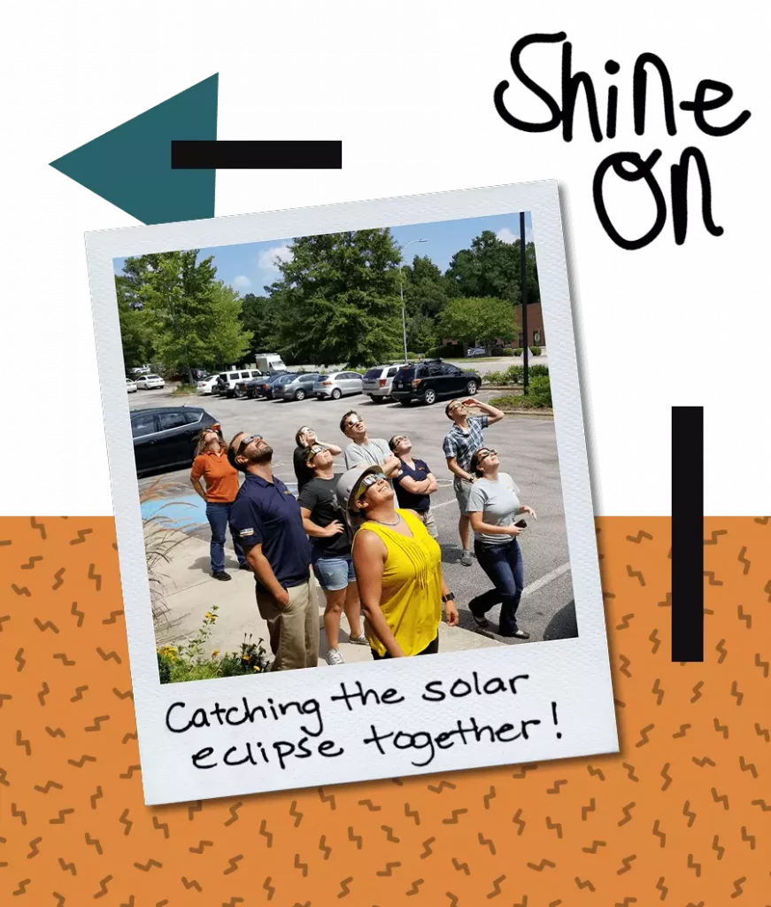 The team at Southern Energy Management checking out a solar eclipse in the parking lot