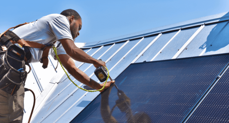 A solar installer from Southern Energy installs solar on a metal roof of a home