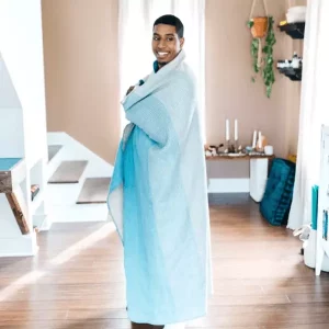 Person wrapped in a blue oversized blanket from Thread Talk
