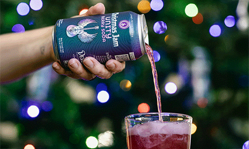 A can of Christmas Unity Berry soda from Devil's Foot pouring into a glass cup