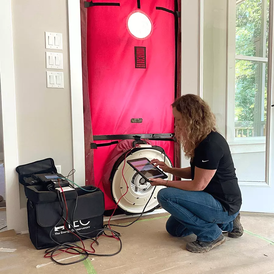 Sara, building performance expert from Southern Energy Management, tests a home's efficiency using a blower door