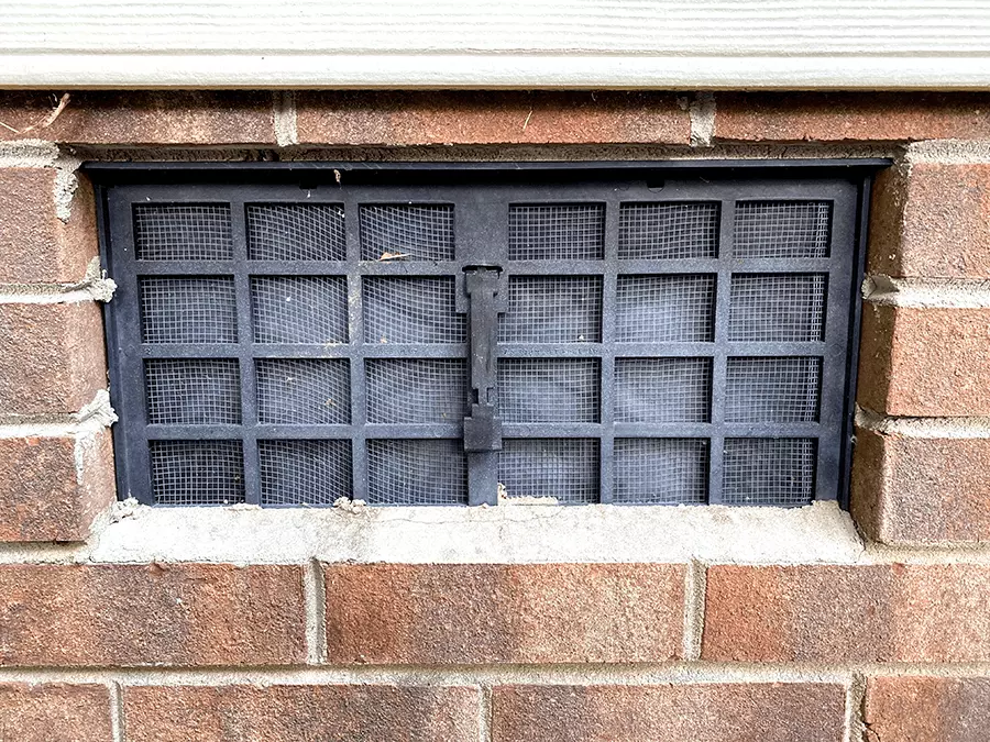 Exterior view of a closed crawl space vent