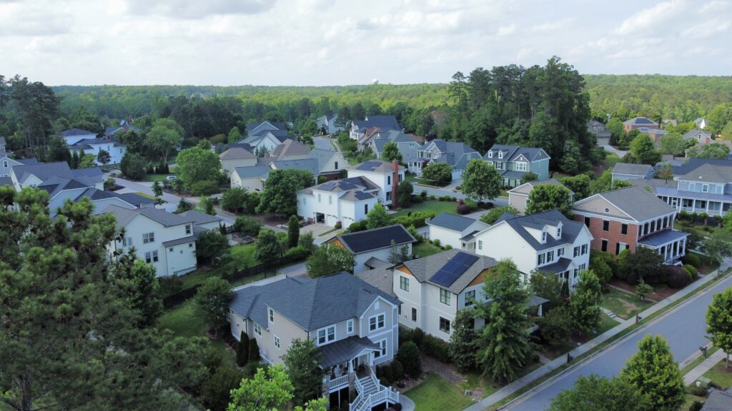 Drone shot of a neighborhood with multiple solar installs