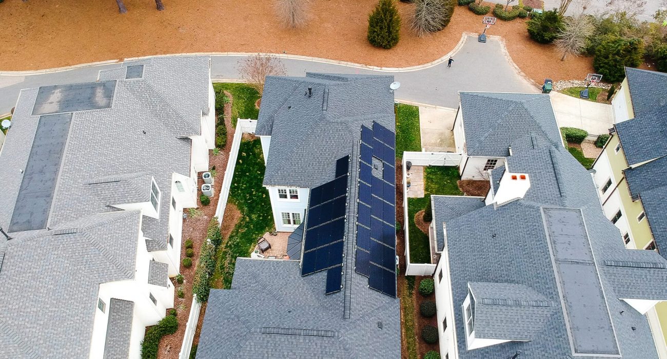 Aerial view of a roof top solar system installed on grey shingles