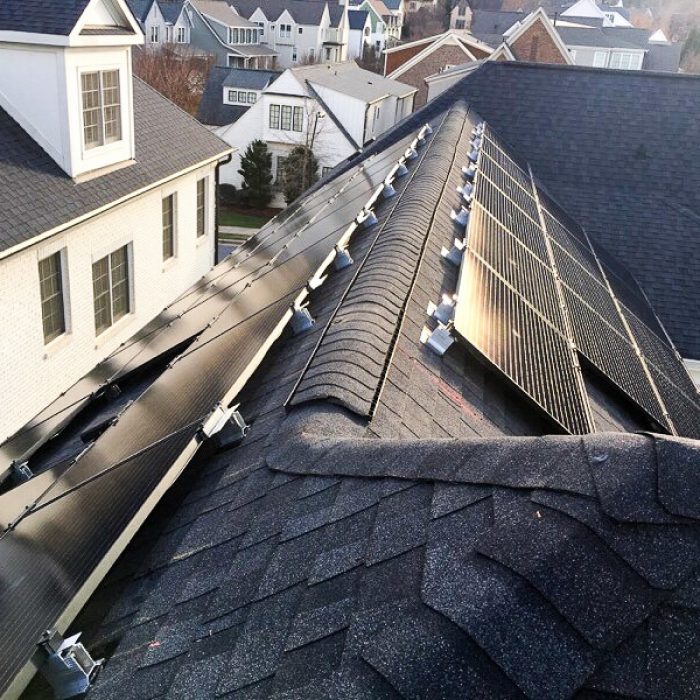 Sunset reflecting of solar system installed on a shingled roof