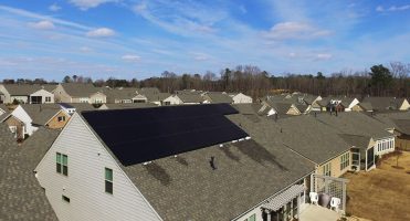 New construction home in an neighborhood with solar on the roof