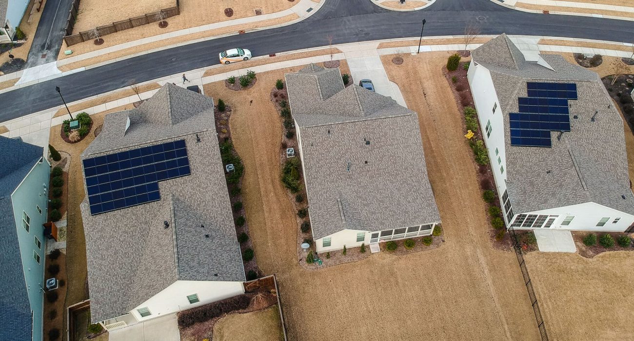 Aerial view of two homes with rooftop solar systems installed