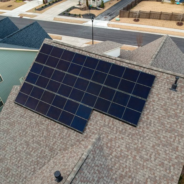 Rooftop solar system on a tan shingle roof