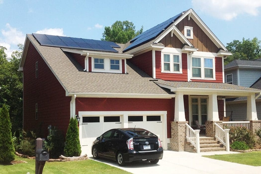 Street view of a roof top solar system on a red craftsman home