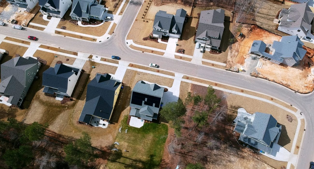 Aerial view of a home with solar in a neighborhood