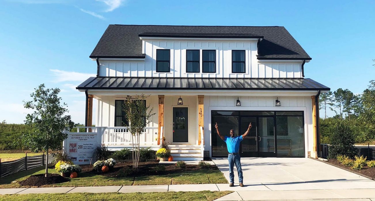 Shine On Champ, Robert Thornton in front of the newly completed Garman Model Home at Wendell Falls
