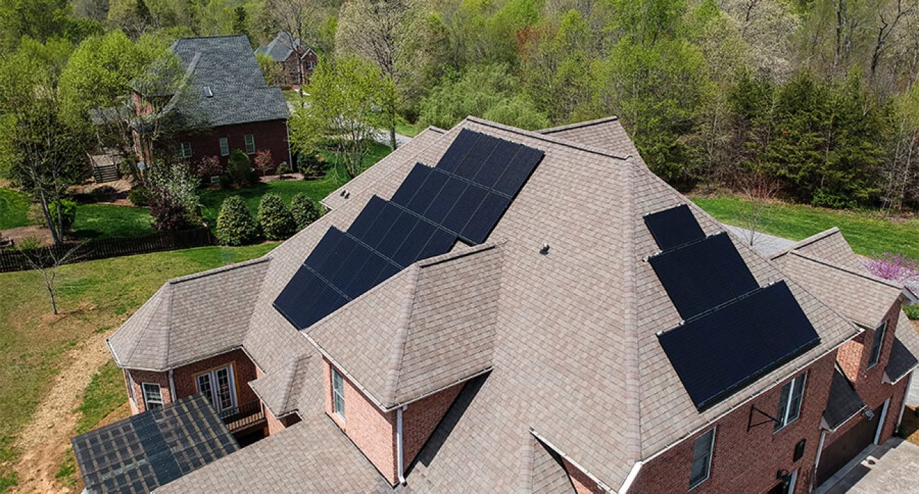 View of a black solar system on a tan roof