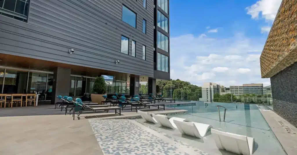 exterior view of lounge chairs beside pool at NOVEL Midtown Atlanta