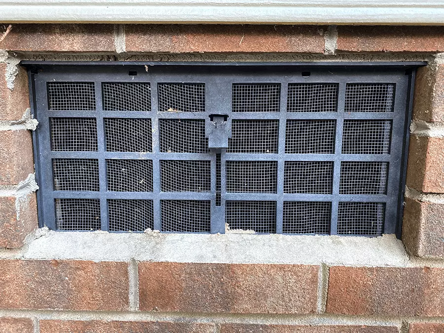 Exterior view of an open crawl space vent