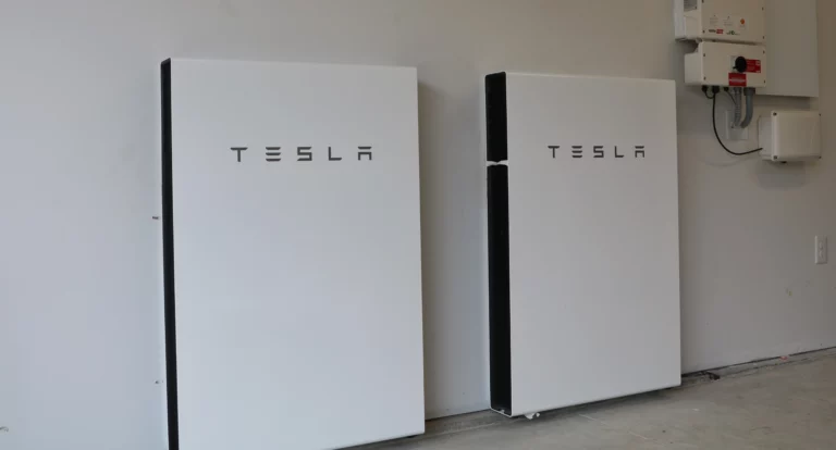 Pair of white tesla powerwalls installed next to each other in a garage