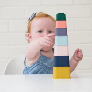 child playing with multicolored stackable cups from Bella Tunno