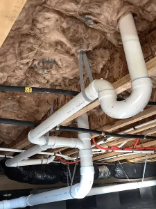 Insulation and plumbing in a vented crawl space