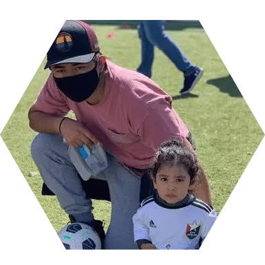 Rey, DC Foreman with his daughter at a soccer game