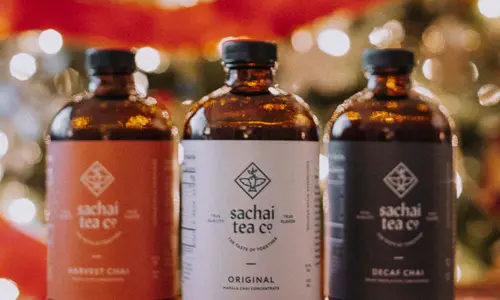 A trio of concentrated chai mixes in amber glass bottles from Sachai Tea
