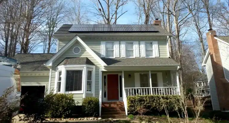 rooftop solar system installed on a sage green cottage home