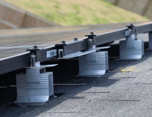 Close up image of footers installed on a roof, holding solar panels into place