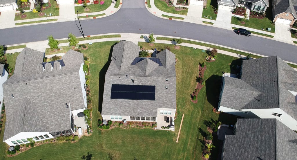 Aerial view of a home with a mono panel solar system installed on the roof